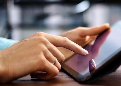 Person holding a tablet in their hand